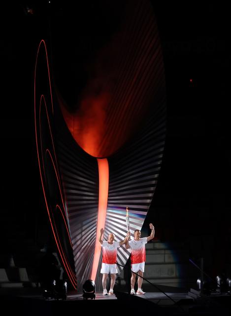 (260919) -- NAGOYA, Sept. 19, 2026 (Xinhua) -- Torch bearers Murofushi Shigenobu (L) and Murofushi Koji wave after the cauldron is lit during the opening ceremony of the 20th Asian Games Aichi-Nagoya 2026 in Nagoya, Japan, Sept. 19, 2026. (Xinhua/Wang Fei)