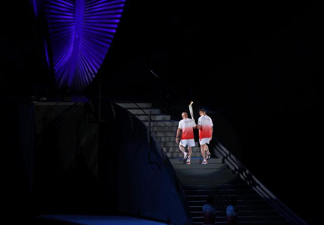 (260919) -- NAGOYA, Sept. 19, 2026 (Xinhua) -- Torch bearers Murofushi Shigenobu (L) and Murofushi Koji prepare to light the cauldron during the opening ceremony of the 20th Asian Games Aichi-Nagoya 2026 in Nagoya, Japan, Sept. 19, 2026. (Xinhua/Wang Fei)
