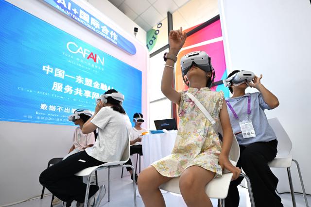 (260919) -- NANNING, Sept. 19, 2026 (Xinhua) -- Visitors experience AI movies during the 23rd China-ASEAN Expo in Nanning, south China's Guangxi Zhuang Autonomous Region, Sept. 19, 2026. AI-related products have taken center stage at the ongoing 23rd China-ASEAN Expo, which attracts more than 3,400 companies from China, the Association of Southeast Asian Nations (ASEAN) and beyond. (Xinhua/Huang Xiaobang)