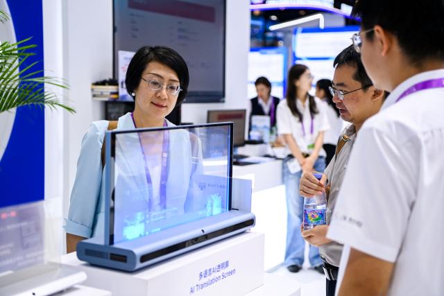 (260919) -- NANNING, Sept. 19, 2026 (Xinhua) -- Visitors learn about an AI-powered multilingual transparent display during the 23rd China-ASEAN Expo in Nanning, south China's Guangxi Zhuang Autonomous Region, Sept. 18, 2026. AI-related products have taken center stage at the ongoing 23rd China-ASEAN Expo, which attracts more than 3,400 companies from China, the Association of Southeast Asian Nations (ASEAN) and beyond. (Xinhua/Cao Yiming)