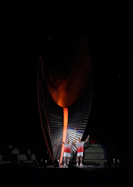 (260919) -- NAGOYA, Sept. 19, 2026 (Xinhua) -- Torch bearers Murofushi Shigenobu (L) and Murofushi Koji wave after the cauldron is lit during the opening ceremony of the 20th Asian Games Aichi-Nagoya 2026 in Nagoya, Japan, Sept. 19, 2026. (Xinhua/Zhou Mi)