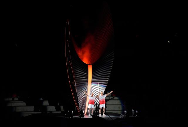 (260919) -- NAGOYA, Sept. 19, 2026 (Xinhua) -- Torch bearers Murofushi Shigenobu (L) and Murofushi Koji wave after the cauldron is lit during the opening ceremony of the 20th Asian Games Aichi-Nagoya 2026 in Nagoya, Japan, Sept. 19, 2026. (Xinhua/Zhou Mi)