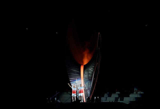 (260919) -- NAGOYA, Sept. 19, 2026 (Xinhua) -- Torch bearers Murofushi Shigenobu (L) and Murofushi Koji wave after the cauldron is lit during the opening ceremony of the 20th Asian Games Aichi-Nagoya 2026 in Nagoya, Japan, Sept. 19, 2026. (Xinhua/Li Bo)