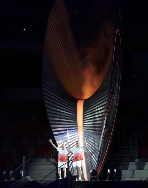 (260919) -- NAGOYA, Sept. 19, 2026 (Xinhua) -- Torch bearers Murofushi Shigenobu (L) and Murofushi Koji wave after the cauldron is lit during the opening ceremony of the 20th Asian Games Aichi-Nagoya 2026 in Nagoya, Japan, Sept. 19, 2026. (Xinhua/Li Bo)