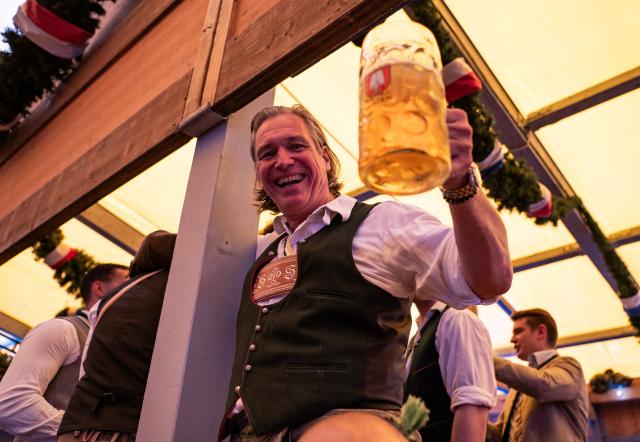 (260919) -- MUNICH, Sept. 19, 2026 (Xinhua) -- A man enjoys beer at the Oktoberfest in Munich, Germany, Sept. 19, 2026. The 191st Oktoberfest, one of the largest folk festivals in Germany, opened on Saturday in Munich, with mayor Dominik Krause tapping the first barrel of beer as a tradition. This year's festival will last until Oct. 4. (Xinhua/Zhang Haofu)
