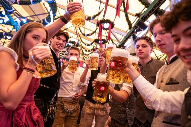 (260919) -- MUNICH, Sept. 19, 2026 (Xinhua) -- People enjoy beer at the Oktoberfest in Munich, Germany, Sept. 19, 2026. The 191st Oktoberfest, one of the largest folk festivals in Germany, opened on Saturday in Munich, with mayor Dominik Krause tapping the first barrel of beer as a tradition. This year's festival will last until Oct. 4. (Xinhua/Zhang Haofu)
