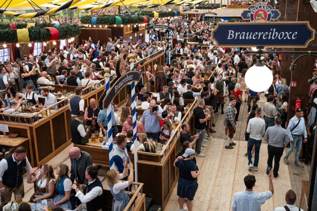 (260919) -- MUNICH, Sept. 19, 2026 (Xinhua) -- People enjoy beer at the Oktoberfest in Munich, Germany, Sept. 19, 2026. The 191st Oktoberfest, one of the largest folk festivals in Germany, opened on Saturday in Munich, with mayor Dominik Krause tapping the first barrel of beer as a tradition. This year's festival will last until Oct. 4. (Xinhua/Zhang Haofu)