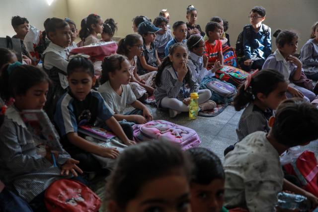 (260919) -- GAZA, Sept. 19, 2026 (Xinhua) -- Palestinian students attend first day of the new school year at an UNRWA school, in Nuseirat, in the central Gaza Strip, on Sept. 19, 2026. TO GO WITH "Feature: Gaza reopens schools for in-person learning after 3-year hiatus" (Photo by Rizek Abdeljawad/Xinhua)