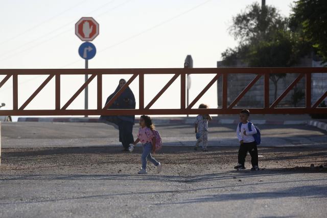 (260919) -- NABLUS, Sept. 19, 2026 (Xinhua) -- Palestinian children pass through a closed Israeli checkpoint gate in the village of Qusra, south of Nablus, in the West Bank, on Sept. 16, 2026. TO GO WITH "Feature: A journey to school through fear and barriers" (Photo by Nidal Eshtayeh/Xinhua)