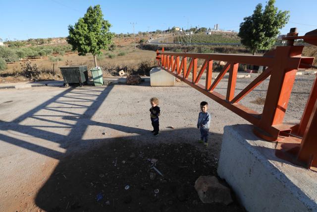 (260919) -- NABLUS, Sept. 19, 2026 (Xinhua) -- Palestinian children pass through a closed Israeli checkpoint gate in the village of Qusra, south of Nablus, in the West Bank, on Sept. 16, 2026. TO GO WITH "Feature: A journey to school through fear and barriers" (Photo by Nidal Eshtayeh/Xinhua)