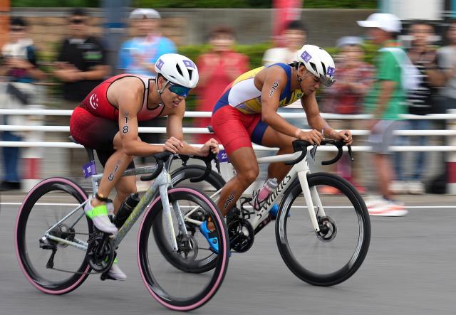 (260920) -- NAGOYA, Sept. 20, 2026 (Xinhua) -- Inaki Emil Lorbes (R) of the Philippines and Tey Yi Jun of Singapore compete during the men's individual triathlon at the 20th Asian Games Aichi-Nagoya 2026 in Gamagori City of Aichi prefecture, Japan, Sept. 20, 2026. (Xinhua/Cen Yunpeng)