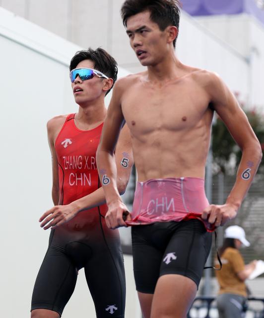 (260920) -- NAGOYA, Sept. 20, 2026 (Xinhua) -- Fan Junjie (R) and Zhang Xirui of China react after the men's individual triathlon final at the 20th Asian Games Aichi-Nagoya 2026 in Gamagori City of Aichi prefecture, Japan, Sept. 20, 2026. (Xinhua/Deng Hua)