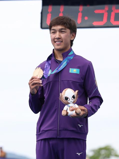 (260920) -- NAGOYA, Sept. 20, 2026 (Xinhua) -- Bronze medalist Arlan Zhanabay of Kazakhstan poses during the victory ceremony for the men's individual final of triathlon at the 20th Asian Games Aichi-Nagoya 2026 in Gamagori City of Aichi Prefecture, Japan, Sept. 20, 2026. (Xinhua/Deng Hua)