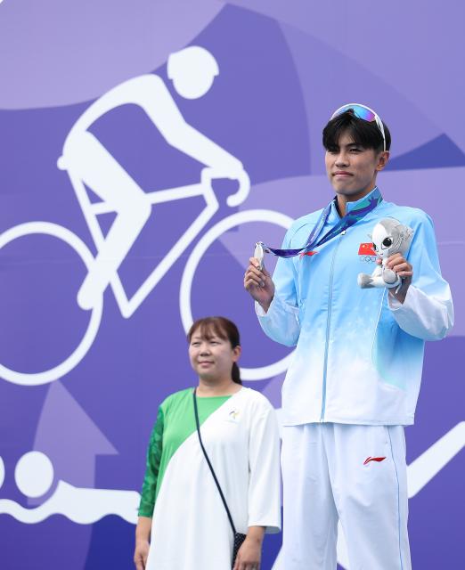 (260920) -- NAGOYA, Sept. 20, 2026 (Xinhua) -- Silver medalist Zhang Xirui of China poses during the victory ceremony for the men's individual final of triathlon at the 20th Asian Games Aichi-Nagoya 2026 in Gamagori City of Aichi Prefecture, Japan, Sept. 20, 2026. (Xinhua/Deng Hua)