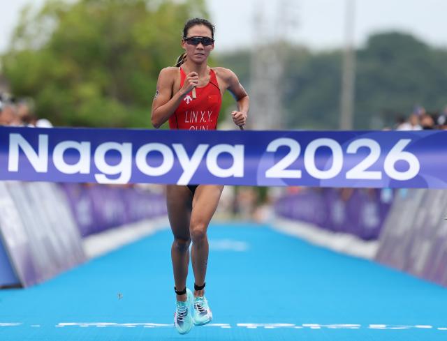 (260920) -- NAGOYA, Sept. 20, 2026 (Xinhua) -- Lin Xinyu of China crosses the finish line during the women's individual triathlon final at the 20th Asian Games Aichi-Nagoya 2026 in Gamagori City of Aichi Prefecture, Japan, Sept. 20, 2026. (Xinhua/Deng Hua)
