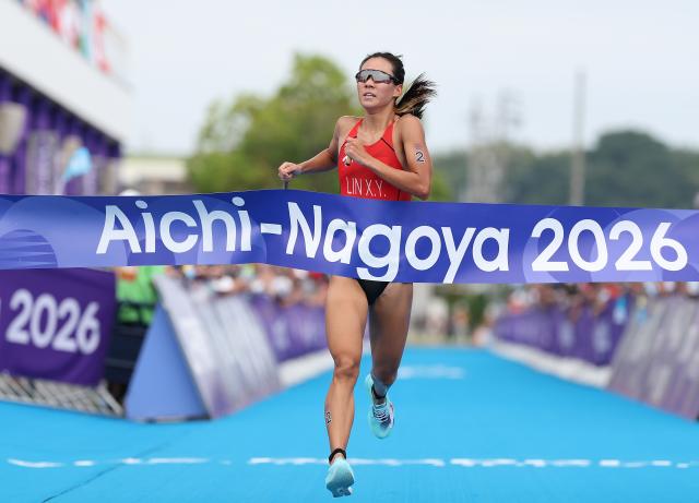 (260920) -- NAGOYA, Sept. 20, 2026 (Xinhua) -- Lin Xinyu of China crosses the finish line during the women's individual triathlon final at the 20th Asian Games Aichi-Nagoya 2026 in Gamagori City of Aichi Prefecture, Japan, Sept. 20, 2026. (Xinhua/Deng Hua)