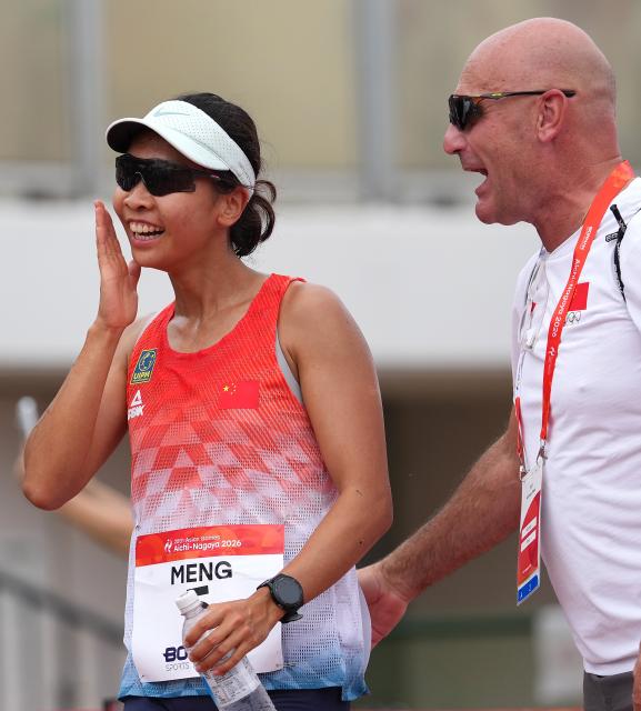 (260920) -- NAGOYA, Sept. 20, 2026 (Xinhua) -- Meng Xin (L) of China celebrates after the women's individual final, laser run round of modern pentathlon at the 20th Asian Games Aichi-Nagoya 2026 in Anjo city of Aichi Prefecture, Japan, Sept. 20, 2026. (Xinhua/Zhou Mi)