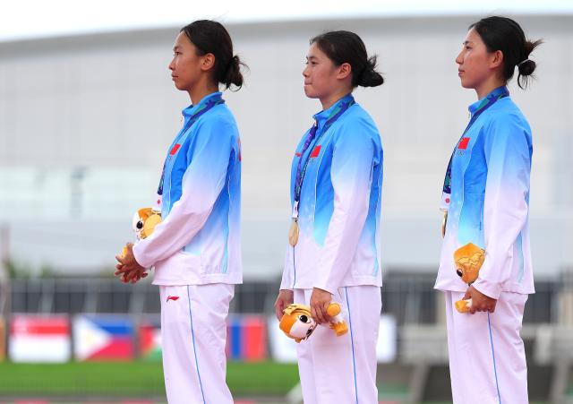 (260920) -- NAGOYA, Sept. 20, 2026 (Xinhua) -- Meng Xin, Wu Xiyao and Zhang Mingyu (from L to R) of team China react on the podium during the victory ceremony for the women's team of modern pentathlon at the 20th Asian Games Aichi-Nagoya 2026 in Anjo city of Aichi Prefecture, Japan, Sept. 20, 2026. (Xinhua/Zhou Mi)