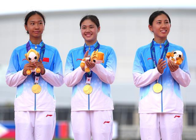 (260920) -- NAGOYA, Sept. 20, 2026 (Xinhua) -- Meng Xin, Wu Xiyao and Zhang Mingyu of team China (from L to R) react on the podium during the victory ceremony for the women's team of modern pentathlon at the 20th Asian Games Aichi-Nagoya 2026 in Anjo city of Aichi Prefecture, Japan, Sept. 20, 2026. (Xinhua/Zhou Mi)