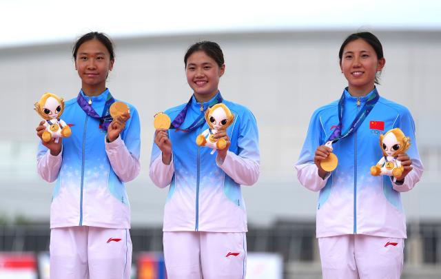 (260920) -- NAGOYA, Sept. 20, 2026 (Xinhua) -- Meng Xin, Wu Xiyao and Zhang Mingyu (from L to R) of team China react on the podium during the victory ceremony for the women's team of modern pentathlon at the 20th Asian Games Aichi-Nagoya 2026 in Anjo city of Aichi Prefecture, Japan, Sept. 20, 2026. (Xinhua/Zhou Mi)