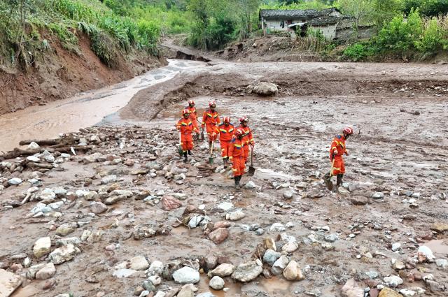 (260921) -- BEIJING, Sept. 21, 2026 (Xinhua) -- A drone photo taken on Sept. 20, 2026 shows rescuers working at the site of a mudslide in Yanbian County, southwest China's Sichuan Province. Two people have been found dead and three others are missing after a mudslide hit southwest China's Sichuan Province early Saturday, local authorities said. (Xinhua/Liu Kun)