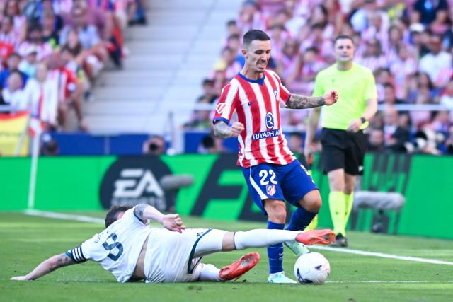 (260921) -- MADRID, Sept. 21, 2026 (Xinhua) -- Atletico de Madrid's Marc Pubill (top) competes during a La Liga football match between Atletico de Madrid and Real Madrid at Riyadh Air Metropolitano stadium in Madrid, Spain, on Sept. 20, 2026. (Photo by Gustavo Valiente/Xinhua)