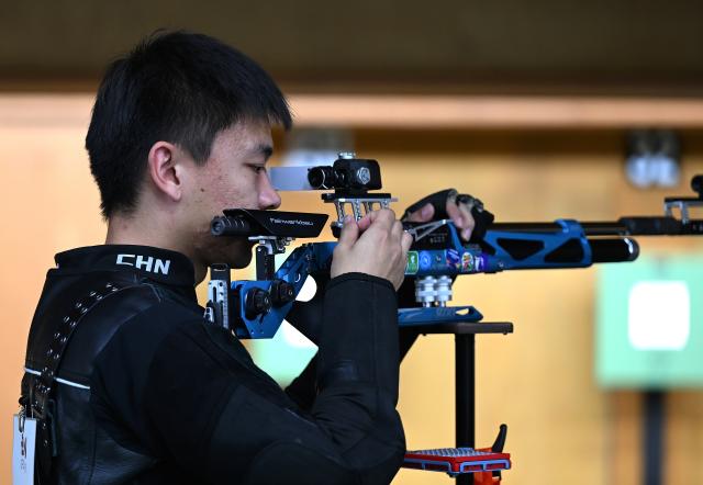 (260921) -- NAGOYA, Sept. 21, 2026 (Xinhua) -- Zhang Changhong of team China reacts during the 10m air rifle men team final of shooting at the 20th Asian Games Aichi-Nagoya 2026 in Toyota of Aichi Prefecture, Japan, Sept. 21, 2026. (Xinhua/Liu Lei)