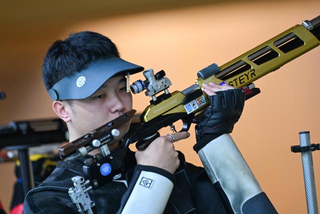 (260921) -- NAGOYA, Sept. 21, 2026 (Xinhua) -- Ma Sihan of team China reacts during the 10m air rifle men team final of shooting at the 20th Asian Games Aichi-Nagoya 2026 in Toyota of Aichi Prefecture, Japan, Sept. 21, 2026. (Xinhua/Liu Lei)