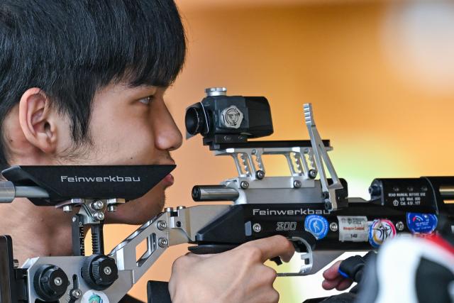 (260921) -- NAGOYA, Sept. 21, 2026 (Xinhua) -- Sheng Lihao of team China reacts during the 10m air rifle men team final of shooting at the 20th Asian Games Aichi-Nagoya 2026 in Toyota of Aichi Prefecture, Japan, Sept. 21, 2026. (Xinhua/Liu Lei)