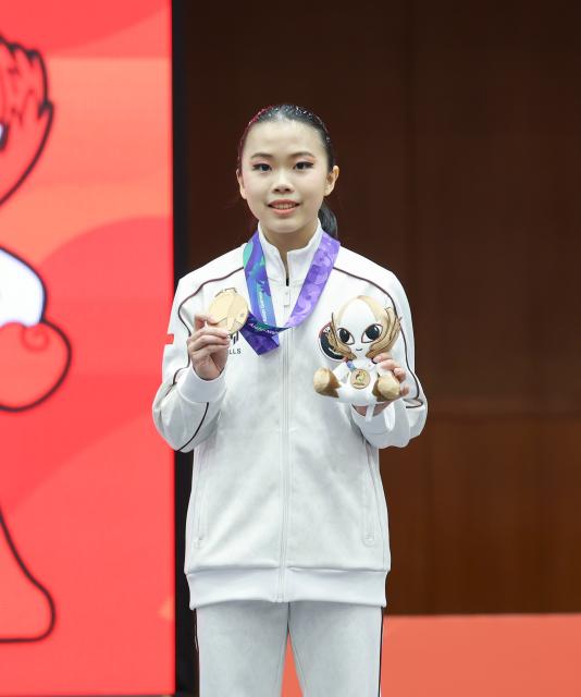 (260921) -- NAGOYA, Sept. 21, 2026 (Xinhua) -- Bronze medalist Eugenia Diva Widodo of Indonesia poses during the victory ceremony for the Women's Changquan of Wushu at the 20th Asian Games Aichi-Nagoya 2026 in Nagoya of Aichi Prefecture, Japan, Sept. 21, 2026. (Xinhua/Long Lei)
