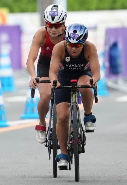 (260921) -- NAGOYA, Sept. 21, 2026 (Xinhua) -- Huang Anqi (L) of team China and Hayashi Manami of team Japan compete during the mixed relay final of triathlon at the 20th Asian Games Aichi-Nagoya 2026 in Gamagori City of Aichi Prefecture, Japan, Sept. 21, 2026. (Xinhua/Zhang Haobo)