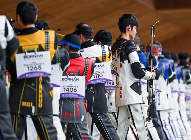 (260921) -- NAGOYA, Sept. 21, 2026 (Xinhua) -- Sheng Lihao (R, front) of team China leaves after the 10m air rifle men team final of shooting at the 20th Asian Games Aichi-Nagoya 2026 in Toyota of Aichi Prefecture, Japan, Sept. 21, 2026. (Xinhua/Liu Lei)
