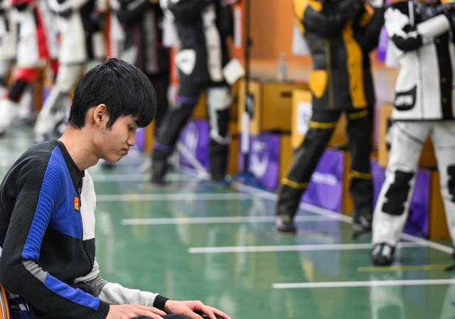 (260921) -- NAGOYA, Sept. 21, 2026 (Xinhua) -- Sheng Lihao of team China takes a break after the 10m air rifle men team final of shooting at the 20th Asian Games Aichi-Nagoya 2026 in Toyota of Aichi Prefecture, Japan, Sept. 21, 2026. (Xinhua/Liu Lei)