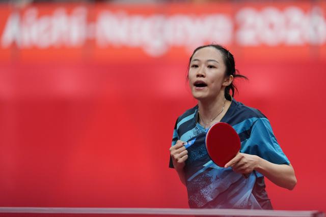 (260921) -- NAGOYA, Sept. 21, 2026 (Xinhua) -- Leong On Na of team China's Macao reacts to Yonggi Poudel of team Nepal during the women's team Group A table tennis match between China's Macao and Nepal at the 20th Asian Games Aichi-Nagoya 2026 in Toyota, Japan, Sept. 21, 2026. (Xinhua/Cheong Kam Ka)