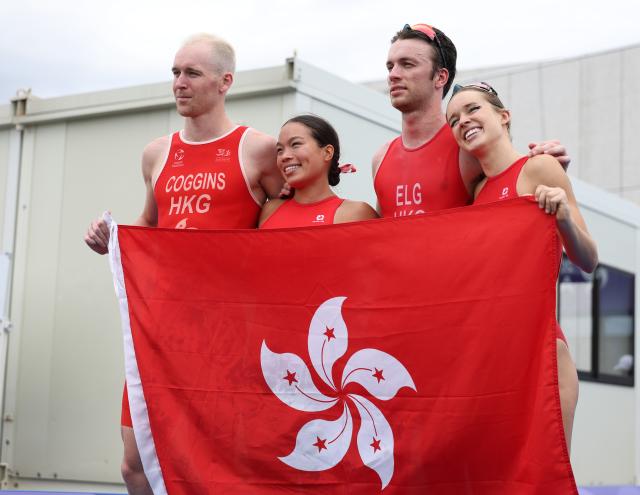 (260921) -- NAGOYA, Sept. 21, 2026 (Xinhua) -- (L to R) Oscar Louis Coggins, Cade Cameron Wright, Robin Bent Edvin Thomas Elg and Bailee Briana Brown of team Hong Kong, China pose to celebrate after the mixed relay final of triathlon at the 20th Asian Games Aichi-Nagoya 2026 in Gamagori City of Aichi Prefecture, Japan, Sept. 21, 2026. (Xinhua/Deng Hua)
