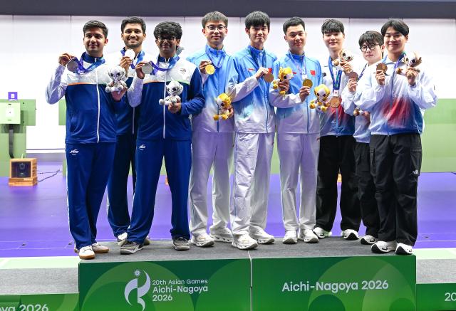 (260921) -- NAGOYA, Sept. 21, 2026 (Xinhua) -- Gold medalists team China (C), silver medalists team India (L) and bronze medalists team South Korea pose during the victory ceremony for the 10m air rifle men team of shooting at the 20th Asian Games Aichi-Nagoya 2026 in Toyota of Aichi Prefecture, Japan, Sept. 21, 2026. (Xinhua/Liu Lei)