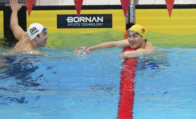 (260921) -- TOKYO, Sept. 21, 2026 (Xinhua) -- Xu Jiayu (R) of China is congratulated by Wang Zicheng of China after the men's 50m backstroke final at the 20th Asian Games Aichi-Nagoya 2026 in Tokyo, Japan, Sept. 21, 2026. (Photo by Wang Shen/Xinhua)