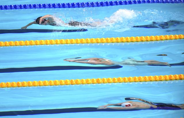 (260921) -- TOKYO, Sept. 21, 2026 (Xinhua) -- Haughey Siobhan (bottom) of Hong Kong of China and Li Jiaping (C) of China competes during the women's 200m freestyle final at the 20th Asian Games Aichi-Nagoya 2026 in Tokyo, Japan, Sept. 21, 2026. (Photo by Wang Shen/Xinhua)