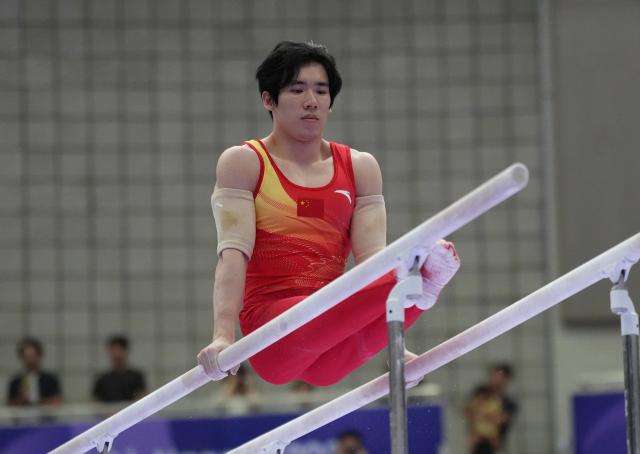 (260921) -- NAGOYA, Sept. 21, 2026 (Xinhua) -- Zhang Boheng of China competes on the parallel bars of the men's all-around final of Artistic Gymnastics at the 20th Asian Games Aichi-Nagoya 2026 in Nagoya, Japan, Sept. 21, 2026. (Xinhua/Jia Yuchen)