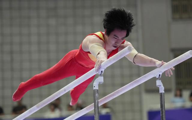 (260921) -- NAGOYA, Sept. 21, 2026 (Xinhua) -- Zhang Boheng of China competes on the parallel bars of the men's all-around final of Artistic Gymnastics at the 20th Asian Games Aichi-Nagoya 2026 in Nagoya, Japan, Sept. 21, 2026. (Xinhua/Jia Yuchen)