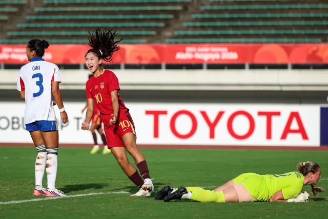 (260921) -- GIFU, Sept. 21, 2026 (Xinhua) -- Wang Yanwen (C) of China celebrates her goal during the group G match of Women's Football between China and the Philippines at 20th Asian Games Aichi-Nagoya 2026 in Gifu, Japan, Sept. 21, 2026. (Xinhua/Jia Haocheng)