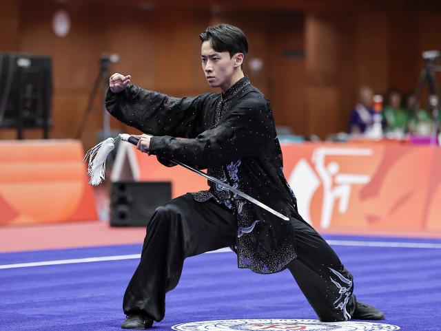(260921) -- NAGOYA, Sept. 21, 2026 (Xinhua) -- An Hyeon-gi of South Korea performs during the Taijijian round of the men's Taijiquan and Taijijian final of Wushu at the 20th Asian Games Aichi-Nagoya 2026 in Nagoya of Aichi Prefecture, Japan, Sept. 21, 2026. (Xinhua/Long Lei)