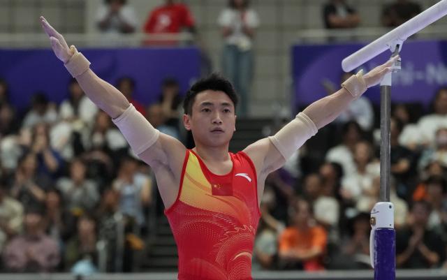 (260921) -- NAGOYA, Sept. 21, 2026 (Xinhua) -- Zou Jingyuan of China gestures after competing on the parallel bars of Artistic Gymnastics at the 20th Asian Games Aichi-Nagoya 2026 in Nagoya, Japan, Sept. 21, 2026. (Xinhua/Jia Yuchen)
