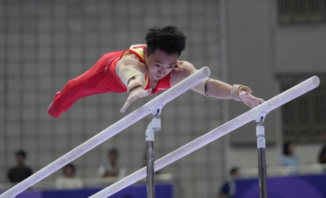 (260921) -- NAGOYA, Sept. 21, 2026 (Xinhua) -- Zou Jingyuan of China competes on the parallel bars of Artistic Gymnastics at the 20th Asian Games Aichi-Nagoya 2026 in Nagoya, Japan, Sept. 21, 2026. (Xinhua/Jia Yuchen)