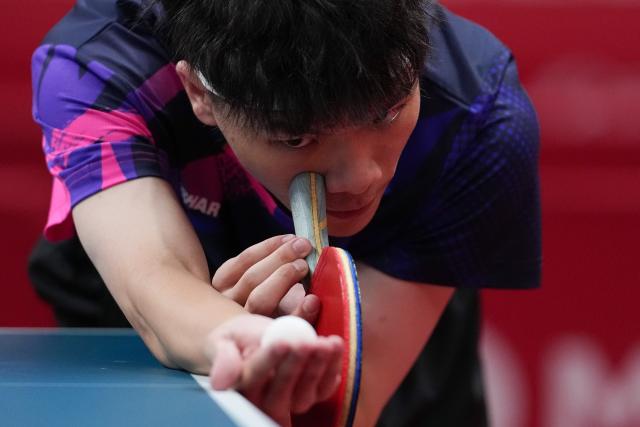 (260921) -- NAGOYA, Sept. 21, 2026 (Xinhua) -- Chan Chi In of Macao of China serves against Mohammed Ahussein of Qatar during the men's team Group A table tennis match between Macao of China and Qatar at the 20th Asian Games Aichi-Nagoya 2026 in Toyota, Japan, Sept. 21, 2026. (Xinhua/Cheong Kam Ka)