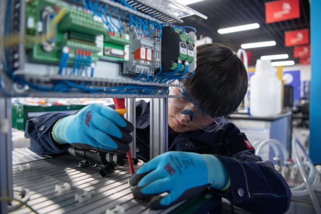 (260921) -- ZHENGZHOU, Sept. 21, 2026 (Xinhua) -- Lu Yi adjusts a device during a simulated competition training at a training base of Henan Chemical Technician College in Kaifeng City, central China's Henan Province, Sept. 1, 2026. At a training base of Henan Chemical Technician College, 23-year-old Lu Yi is preparing for the water technology event of the upcoming 48th WorldSkills Competition.
  Lu enrolled at Henan Chemical Technician College in 2019 and began training for the water technology event three years later. The water technology event focuses on evaluating competitors' abilities in wastewater treatment process operations, water quality analysis, mechanical equipment maintenance, and electrical automation. In 2025, Lu won the gold medal in the water technology event at China's third Vocational Skills Competition.
  During his daily training for the upcoming 48th WorldSkills Competition, Lu spends almost all his time in the laboratory, working with his coach to improve speed and adjust every detail of his movements. (Photo by Kong Weijia/Xinhua)