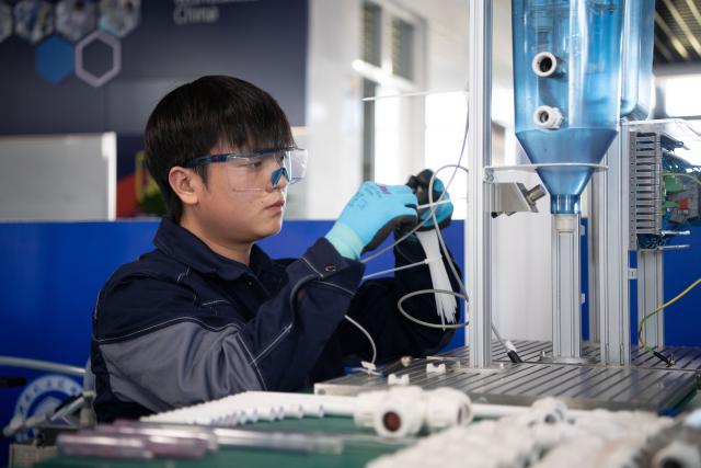(260921) -- ZHENGZHOU, Sept. 21, 2026 (Xinhua) -- Lu Yi adjusts a device during a simulated competition training at a training base of Henan Chemical Technician College in Kaifeng City, central China's Henan Province, Sept. 1, 2026. At a training base of Henan Chemical Technician College, 23-year-old Lu Yi is preparing for the water technology event of the upcoming 48th WorldSkills Competition.
  Lu enrolled at Henan Chemical Technician College in 2019 and began training for the water technology event three years later. The water technology event focuses on evaluating competitors' abilities in wastewater treatment process operations, water quality analysis, mechanical equipment maintenance, and electrical automation. In 2025, Lu won the gold medal in the water technology event at China's third Vocational Skills Competition.
  During his daily training for the upcoming 48th WorldSkills Competition, Lu spends almost all his time in the laboratory, working with his coach to improve speed and adjust every detail of his movements. (Photo by Kong Weijia/Xinhua)