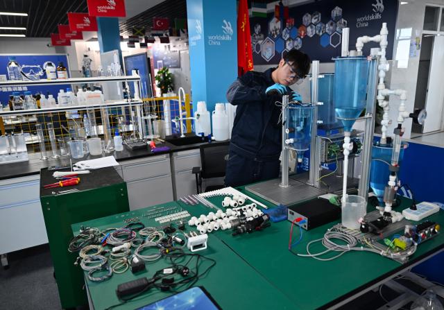 (260921) -- ZHENGZHOU, Sept. 21, 2026 (Xinhua) -- Lu Yi adjusts a device during a simulated competition training at a training base of Henan Chemical Technician College in Kaifeng City, central China's Henan Province, Sept. 1, 2026. At a training base of Henan Chemical Technician College, 23-year-old Lu Yi is preparing for the water technology event of the upcoming 48th WorldSkills Competition.
  Lu enrolled at Henan Chemical Technician College in 2019 and began training for the water technology event three years later. The water technology event focuses on evaluating competitors' abilities in wastewater treatment process operations, water quality analysis, mechanical equipment maintenance, and electrical automation. In 2025, Lu won the gold medal in the water technology event at China's third Vocational Skills Competition.
  During his daily training for the upcoming 48th WorldSkills Competition, Lu spends almost all his time in the laboratory, working with his coach to improve speed and adjust every detail of his movements. (Xinhua/Hao Yuan)