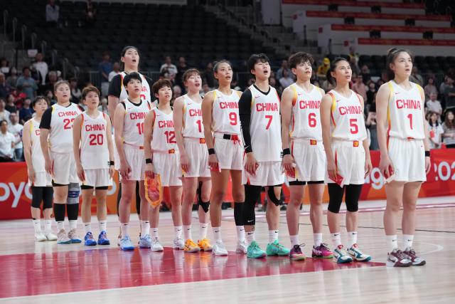 (260921) -- NAGOYA, Sept. 21, 2026 (Xinhua) -- Players of China sing the national anthem before the women's group A basketball match between China and Indonesia at the 20th Asian Games Aichi-Nagoya 2026 in Nagoya, Japan, Sept. 21, 2026. (Xinhua/Luo Yuan)