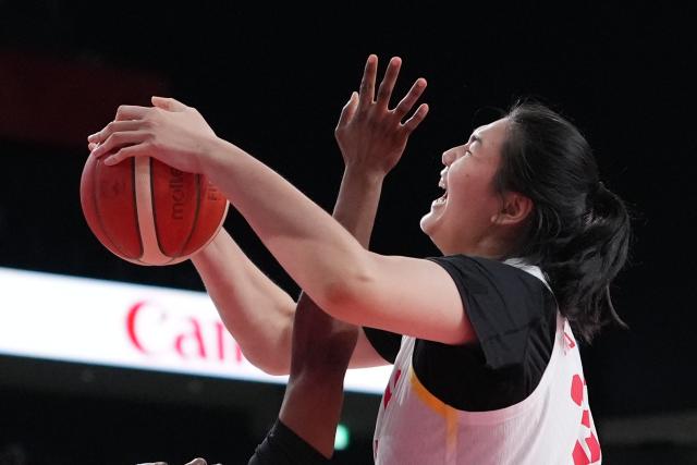 (260921) -- NAGOYA, Sept. 21, 2026 (Xinhua) -- Zhang Ziyu (top) of China competes during the women's group A basketball match between China and Indonesia at the 20th Asian Games Aichi-Nagoya 2026 in Nagoya, Japan, Sept. 21, 2026. (Xinhua/Luo Yuan)